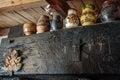 Painted mugs as decoration on an old press in the wine cellar