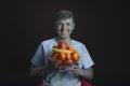 Painted multicolored paints young smiling guy holding a glass va Royalty Free Stock Photo