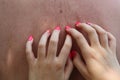 Painted nails scratching somebodys back Royalty Free Stock Photo