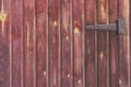 Painted old brown vertical wood planks with old rusty vintage door hinge background Royalty Free Stock Photo