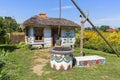 Painted old wooden cottage, well and pail, decorated with a handmade painted flowers, Zalipie, Poland