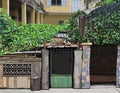 Painted overgrown fence with slum front door