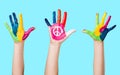 Painted peace sign in girl's hand against war. Royalty Free Stock Photo