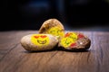 Painted pebbles with emoji faces on a table Royalty Free Stock Photo