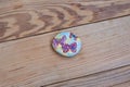 painted pebbles, Stones painted birds and flowers, Decoration. on a wooden table.