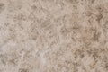 A painted plaster wall texture. An old beige wall background. Royalty Free Stock Photo