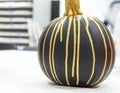 Painted pumpkin for Halloween close up view. Black and golden colors