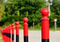 Red steel post and bollards in diminishing perspective. soft green background