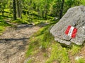 Painted red and white stripes on stone as a sign of directions navigation for tourists or people hiking and trekking, guideposts Royalty Free Stock Photo