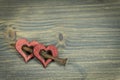 Painted red wooden hearts with rusted nail Royalty Free Stock Photo