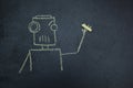 Painted robot on a blackboard with chalk in hand