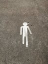 Painted silhouette of a person to signal pedestrians on the road
