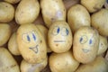 Painted smiling potatoes are ooking to a sad potato Royalty Free Stock Photo