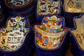 Painted souvenir plates on the counter in the store of Jerusalem, Israel. National ornament on a plate in the form of Hamsa