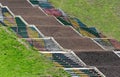 Painted steps of old stairway on a grassy slope in a park