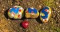 Painted stones in forest showing save and love the NHS