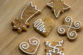 Painted traditional Christmas gingerbreads arranged on wooden background in daylight, common tasty sweets