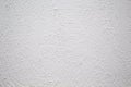 Painted wall with rough texture closeup photo. White plaster with brushed texture. Royalty Free Stock Photo