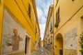 Painted walls on cobbled lane in medieval town