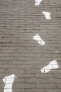 Painted white footprints on pavement Royalty Free Stock Photo