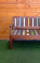 The painted wooden bench with the pastel color on the artificial grass Royalty Free Stock Photo