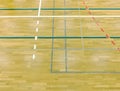 Painted wooden floor of sports hall with colorful marking lines. Schooll gym