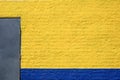 Painted yellow and blue brick wall. Royalty Free Stock Photo