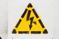 Painted yellow high voltage hazard symbol