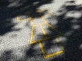 Painted yellow lines contrast against the dark asphalt and form the classic school playground game of Hopscotch Royalty Free Stock Photo