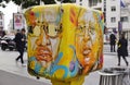 Painted yellow mailbox covered with street art by French graffiti muralist C215 in Paris