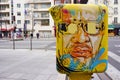 Painted yellow mailbox covered with street art by French graffiti muralist C215 in Paris