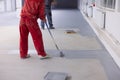 Painter applies heavy traffic gray resin in the new factory