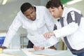 painter and apprentice looking at papers before work Royalty Free Stock Photo