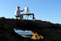 A painter artist is painting a picture about a maritime landscape