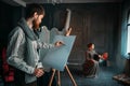 Painter drawing female portrait in art studio