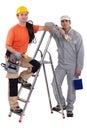 Painter and electrician by ladder Royalty Free Stock Photo