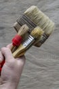 Painter holds the old brushes in his right hand