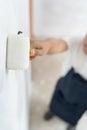 painter man, brush in hand for products to restore and paint the wall, indoor the building site of a house, wall during painting, Royalty Free Stock Photo