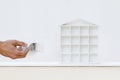 Painter man hand with paint brush painting white house model on Royalty Free Stock Photo