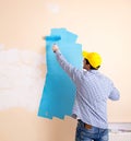 Painter man painting the wall at home Royalty Free Stock Photo
