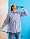 Painter man painting the wall at home Royalty Free Stock Photo