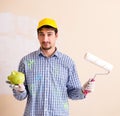 Painter man painting the wall at home Royalty Free Stock Photo