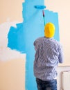 Painter man painting the wall at home Royalty Free Stock Photo