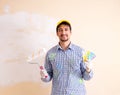 Painter man painting the wall at home Royalty Free Stock Photo