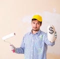 Painter man painting the wall at home Royalty Free Stock Photo