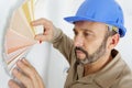 Painter man pointing with finger colors on wall Royalty Free Stock Photo