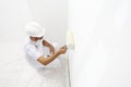 Painter man at work with a paint roller, wall painting Royalty Free Stock Photo