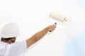 Painter man at work with paint roller, wall painting concept Royalty Free Stock Photo