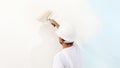 Painter man at work with a paint roller, wall painting Royalty Free Stock Photo