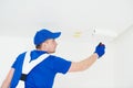 Painter painting ceiling with paint roller Royalty Free Stock Photo